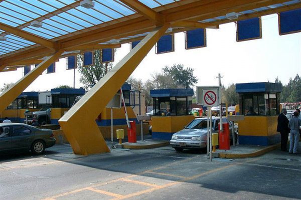 Barrier gate controlling vehicle access at a secure entry point.