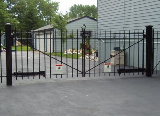 Automated swing gate opener with safety features in residential setting.