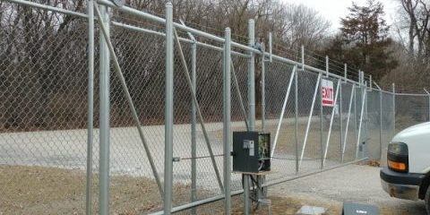 Fenced gate with automated power gate opener system for secure property access.
